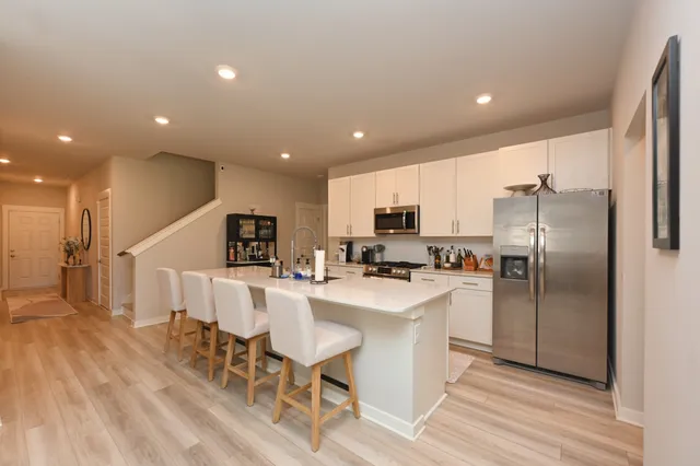 a kitchen with kitchen island stainless steel appliances a refrigerator and microwave