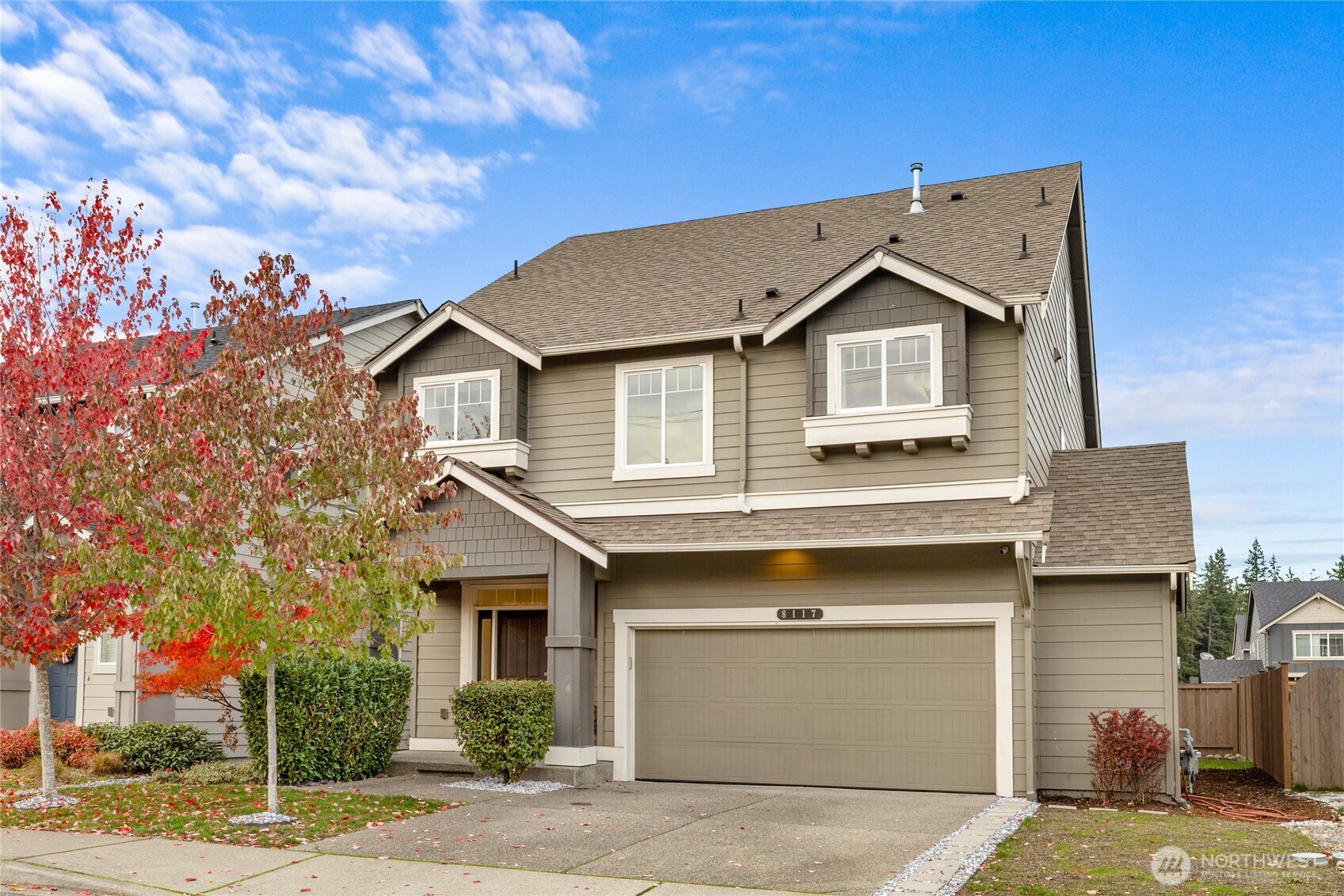 8117 175th St Court East Puyallup, WA 98375 - Photo 1 of 40 a front view of a house with a garage