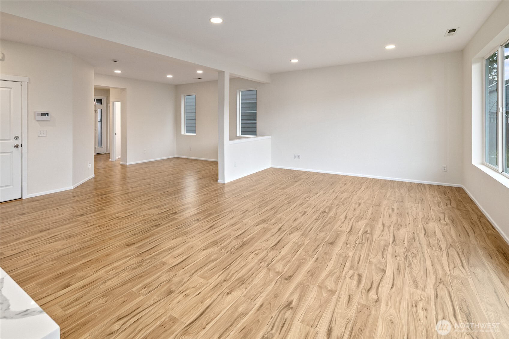 8117 175th St Court East Puyallup, WA 98375 - Photo 14 of 40 a view of an empty room with wooden floor and a window