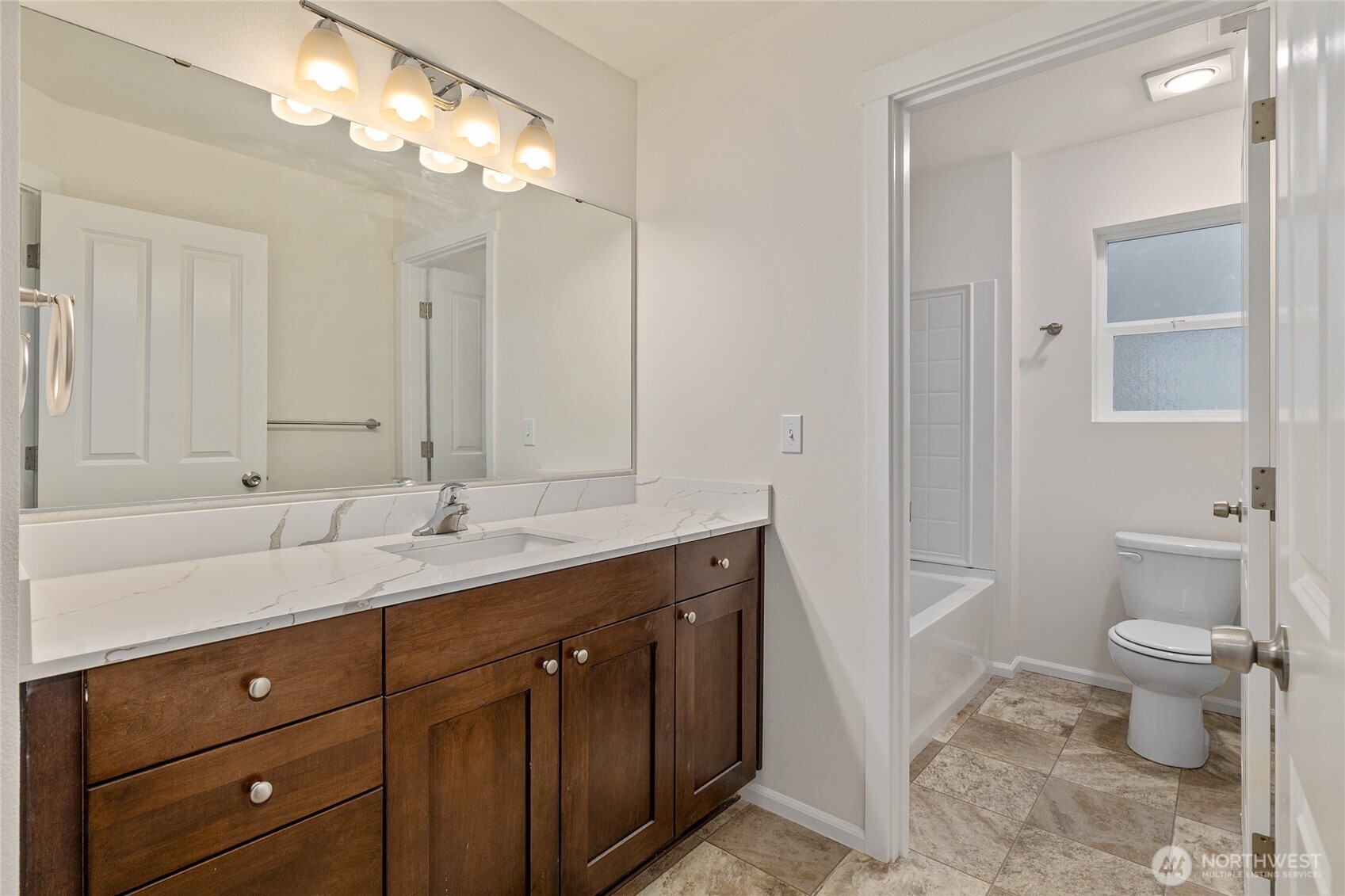 8117 175th St Court East Puyallup, WA 98375 - Photo 22 of 40 a bathroom with a double vanity sink and a toilet