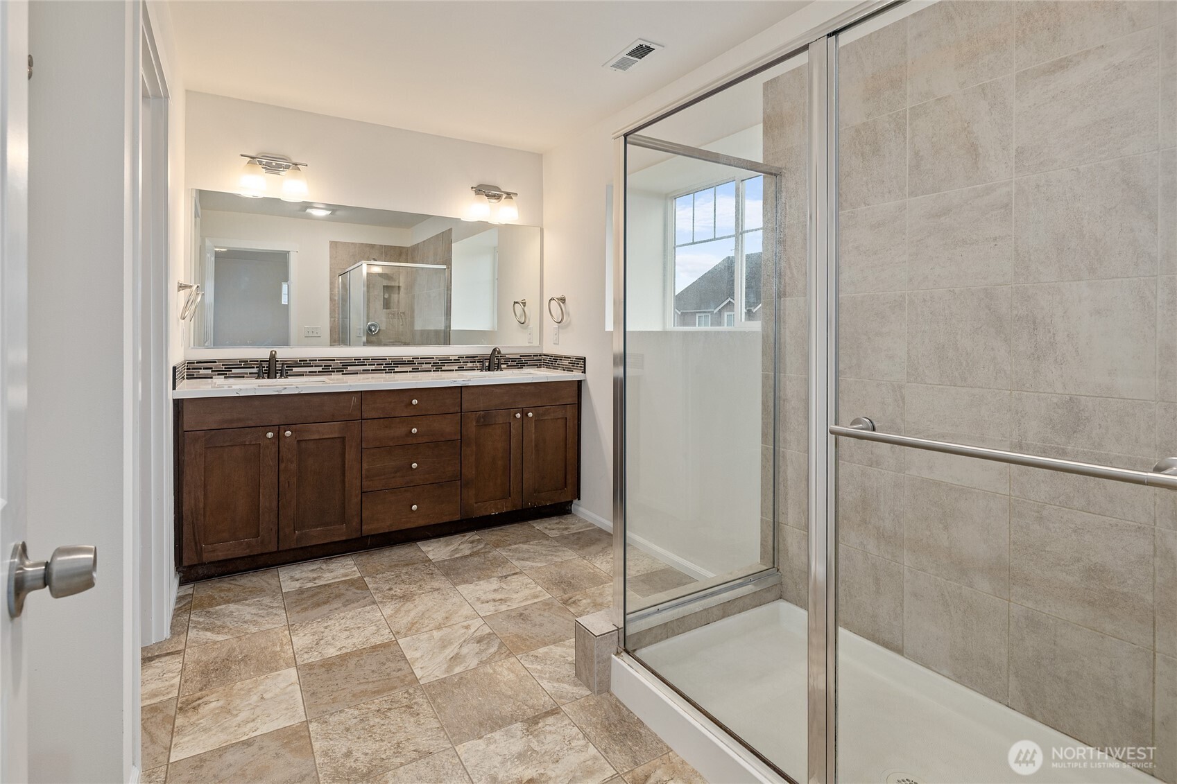 8117 175th St Court East Puyallup, WA 98375 - Photo 31 of 40 a spacious bathroom with a granite countertop sink a mirror and a bathtub