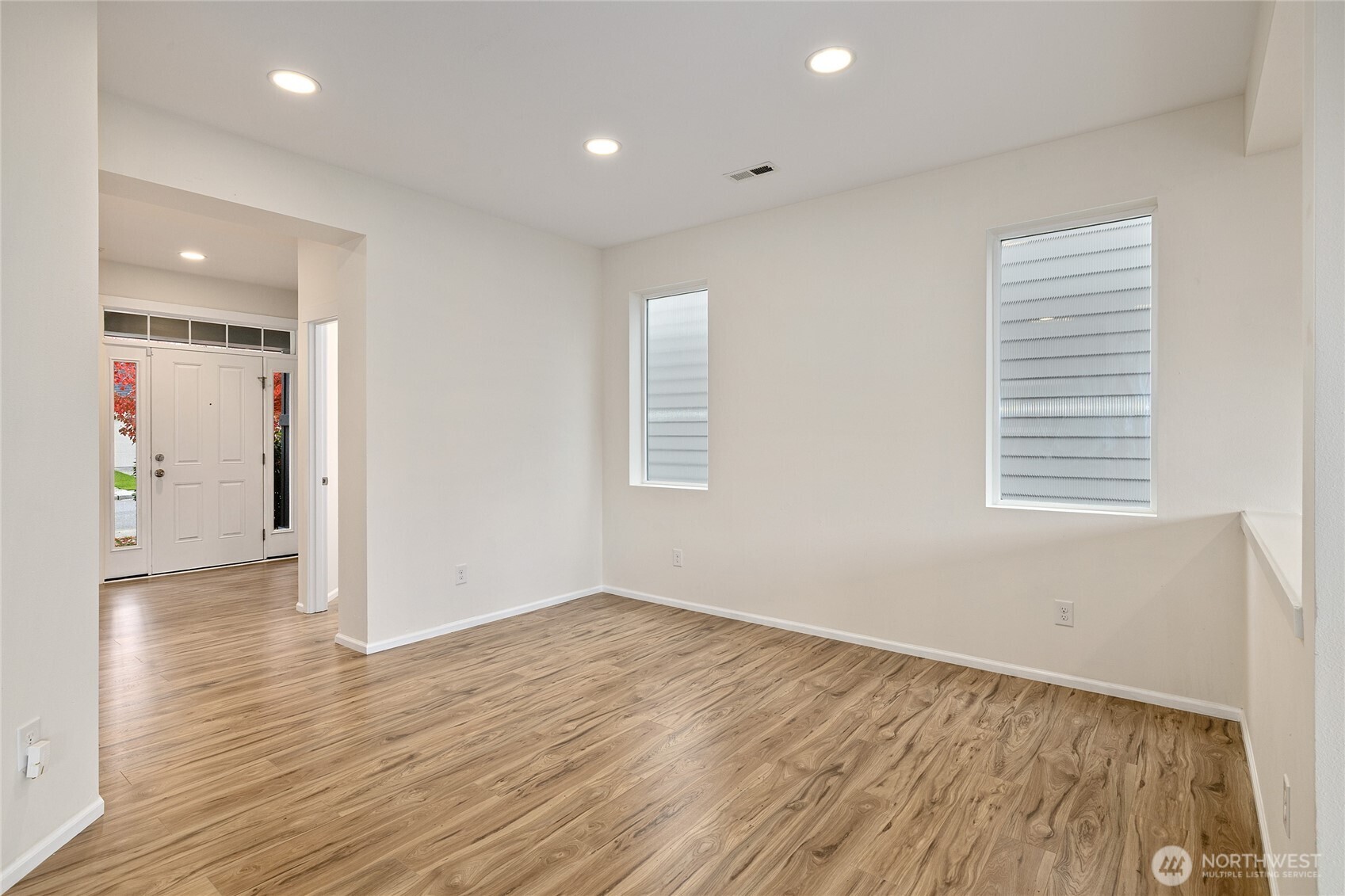 8117 175th St Court East Puyallup, WA 98375 - Photo 5 of 40 an empty room with wooden floor and windows