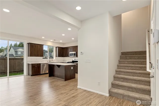 a view of kitchen with sink and refrigerator