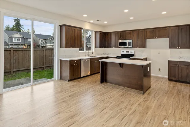 a kitchen with a stove a sink and a microwave