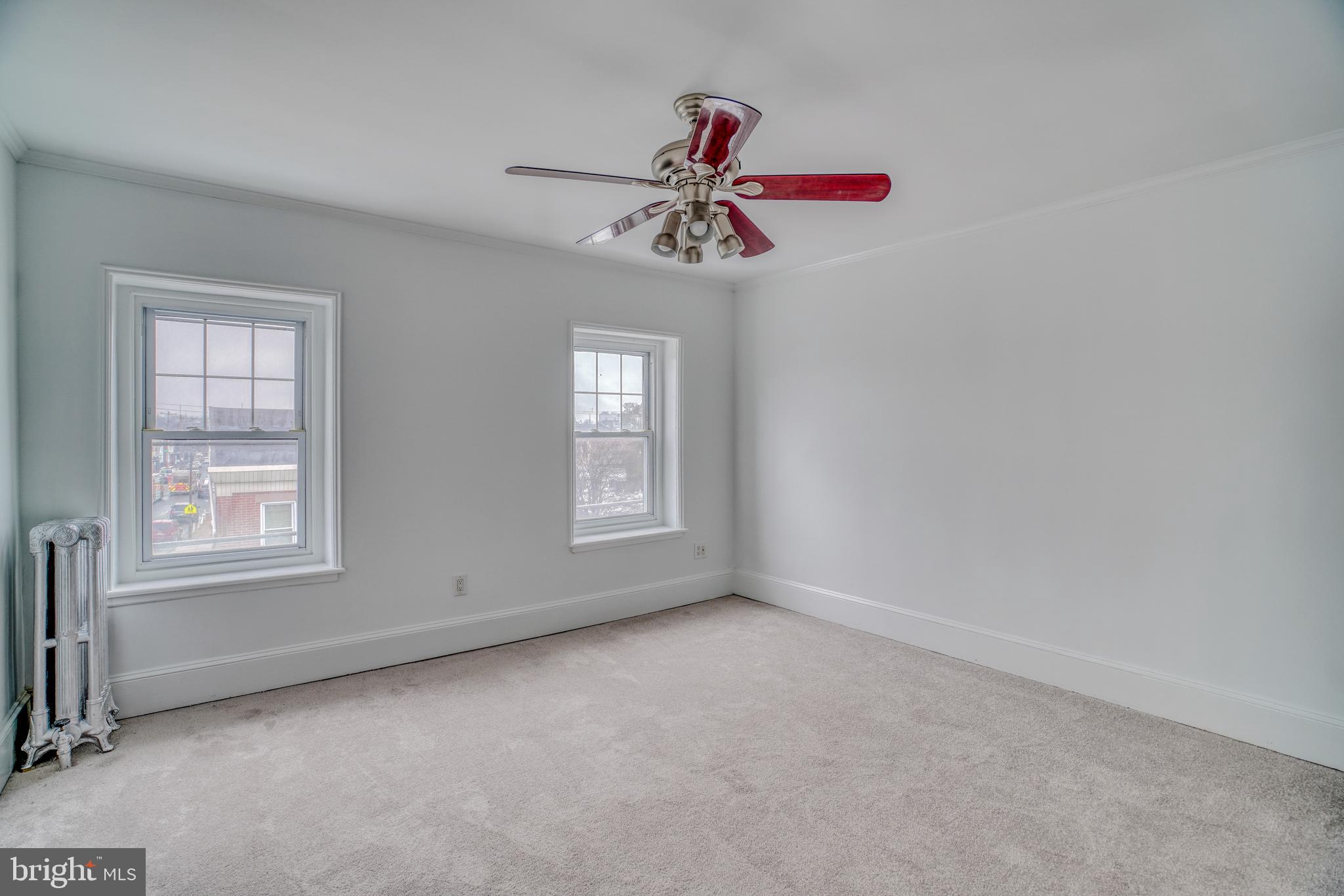4501 Edgemont Street Philadelphia, PA 19137 - Photo 19 of 40 an empty room with chandelier fan and windows