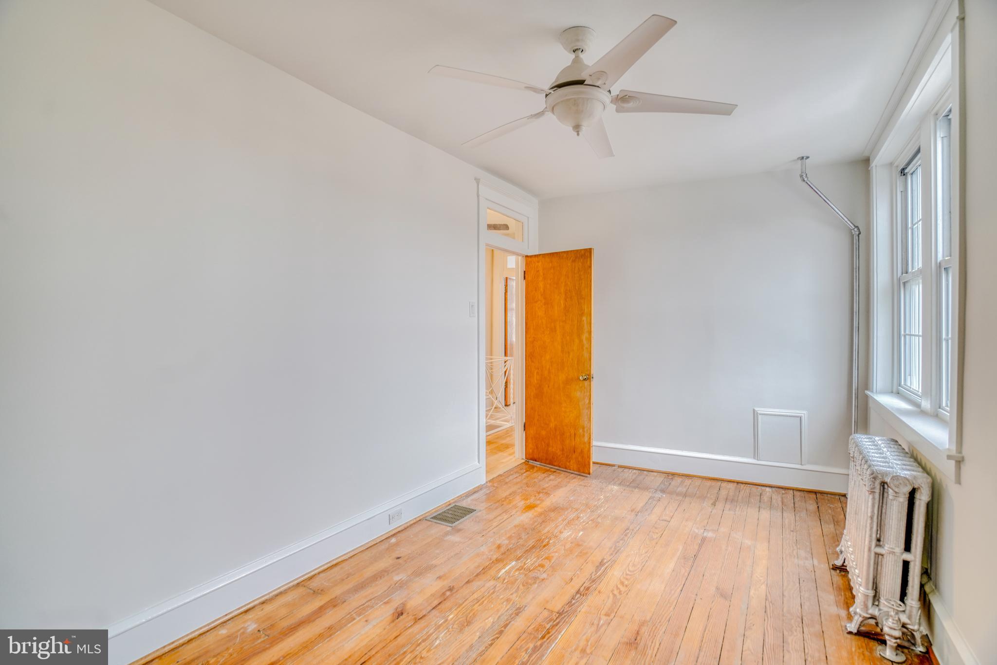 4501 Edgemont Street Philadelphia, PA 19137 - Photo 25 of 40 a view of empty room with wooden floor and fan