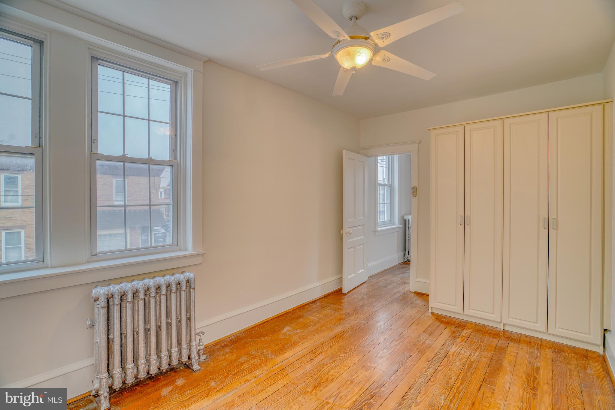 4501 Edgemont Street Philadelphia, PA 19137 - Photo 28 of 40 a view of an empty room with wooden floor and a window