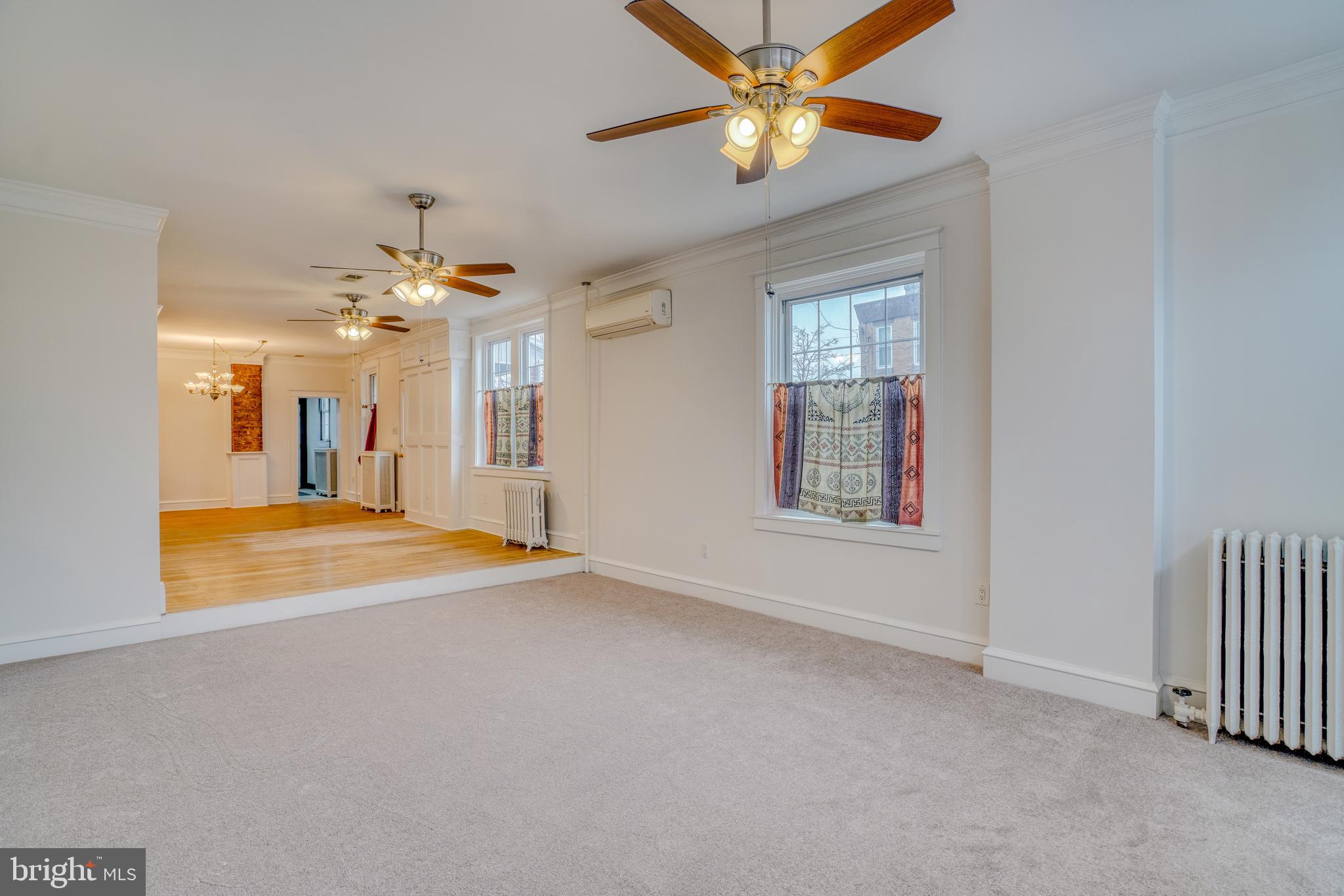 4501 Edgemont Street Philadelphia, PA 19137 - Photo 7 of 40 an empty room with chandelier fan and windows