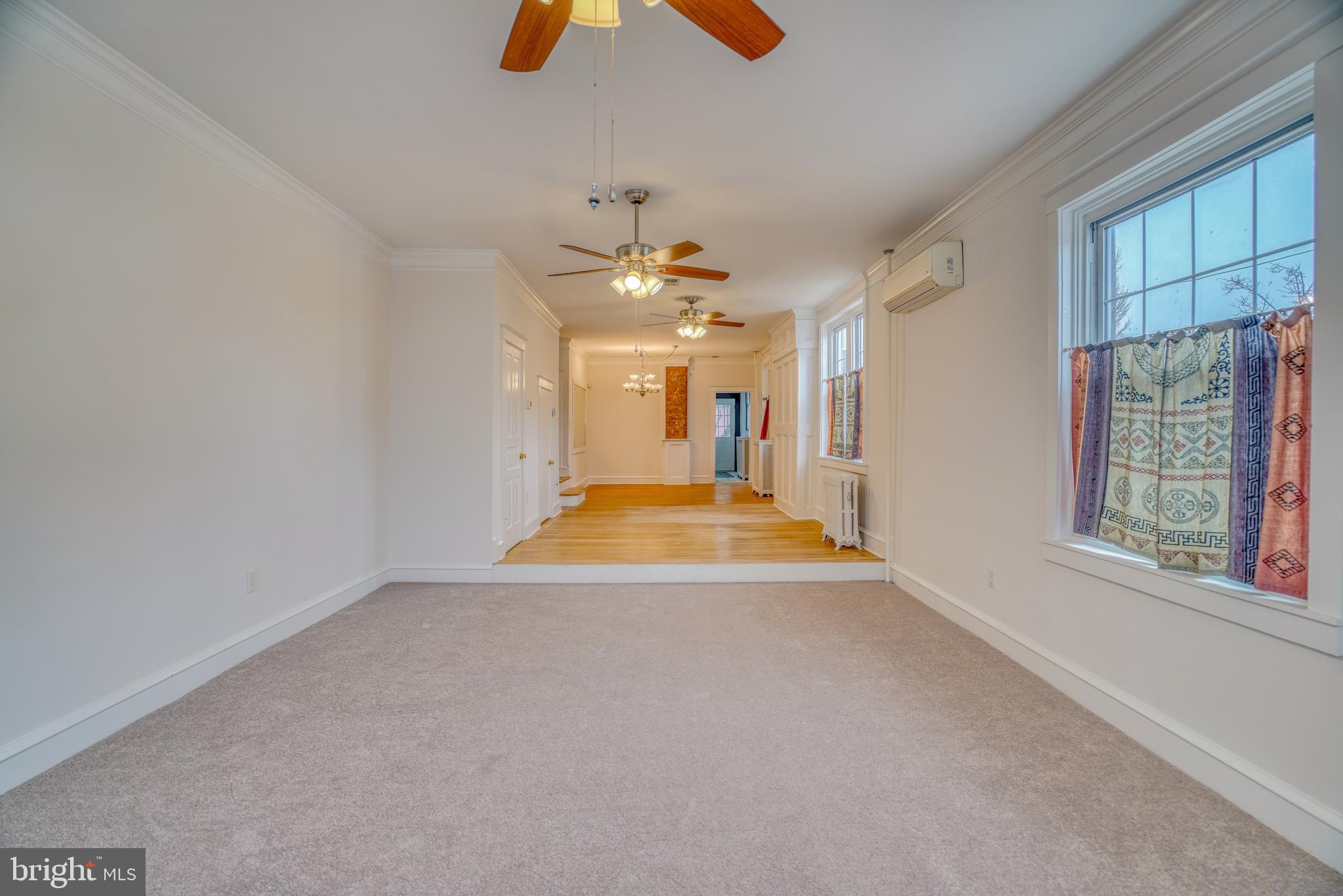 4501 Edgemont Street Philadelphia, PA 19137 - Photo 9 of 40 an empty room with windows and chandelier fan