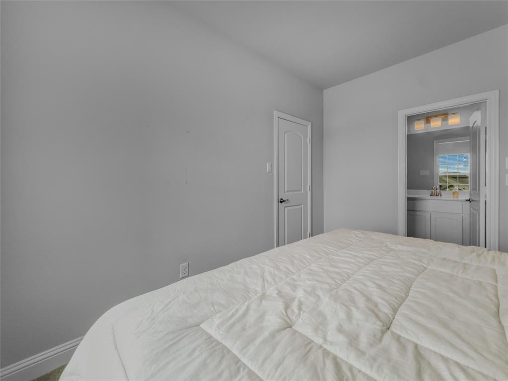 116 Chaco Drive Forney, TX 75126 - Photo 12 of 27 a bedroom with a bed and closet