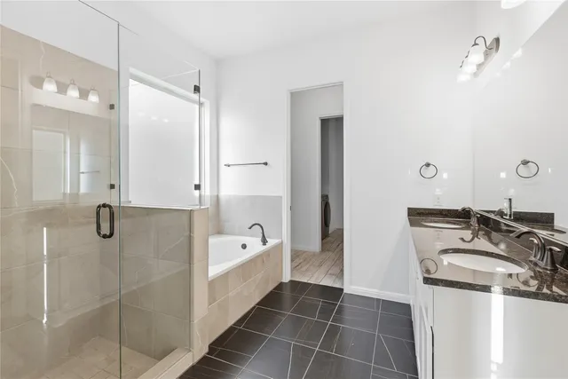 a bathroom with a tub sink and mirror