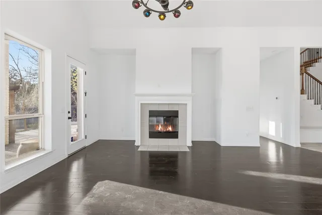 a view of a livingroom with wooden floor and a fireplace