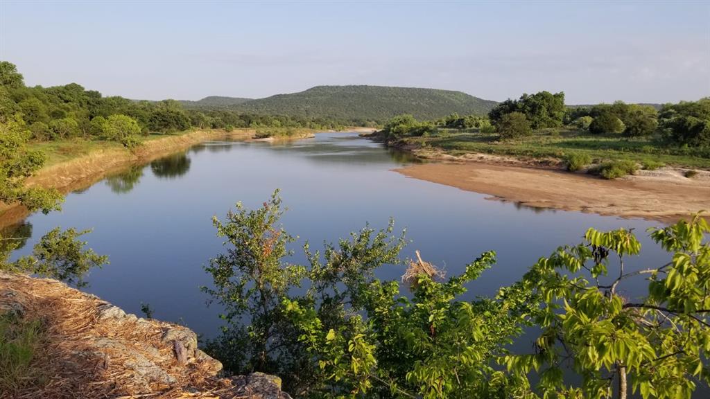Lot # River Canyon Road Palo Pinto, TX 76484 - Photo 4 of 9 a view of a lake with a mountain in the background