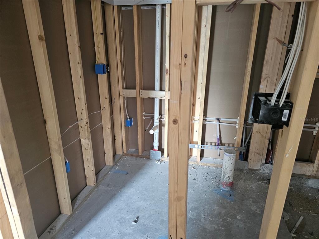 292 Gardenia Road Kissimmee, FL 34743 - Photo 14 of 23 a view of a hallway with wooden cabinets and stairs