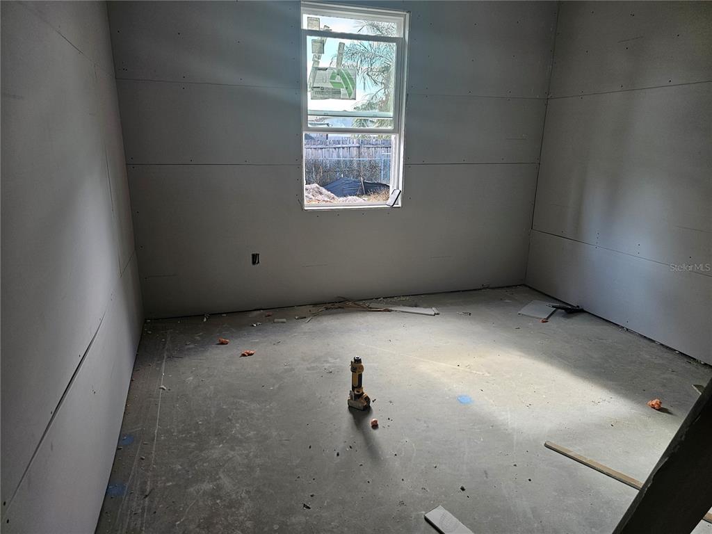 292 Gardenia Road Kissimmee, FL 34743 - Photo 8 of 23 an empty room with windows