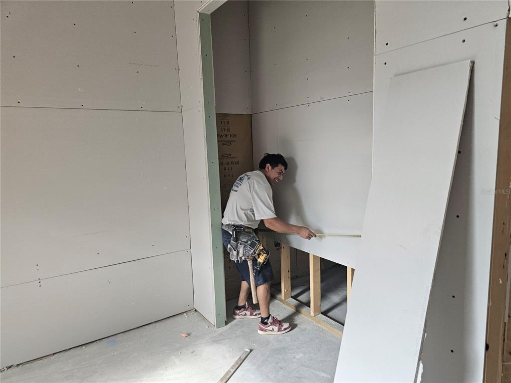 292 Gardenia Road Kissimmee, FL 34743 - Photo 9 of 23 a view of storage and utility room with racks on the wall