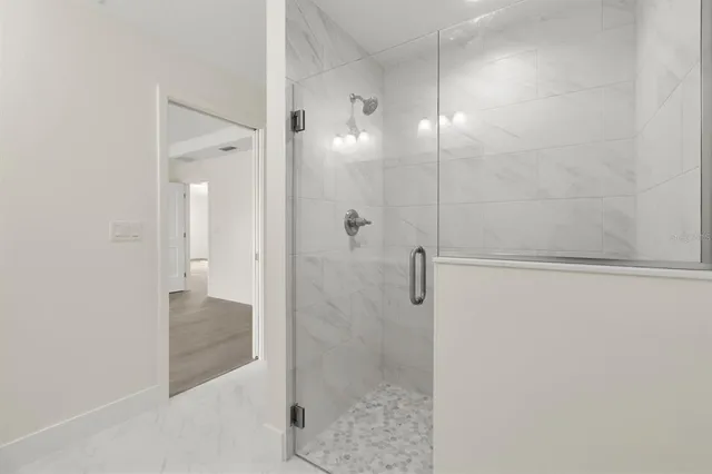 a bathroom with a shower and a sink