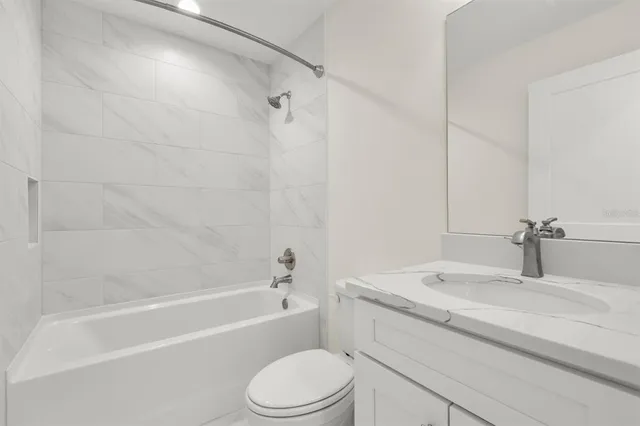 a bathroom with a sink a toilet and a bathtub