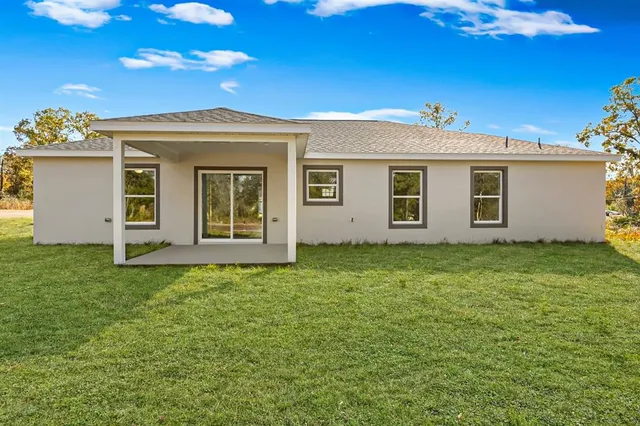 a view of a house with a backyard