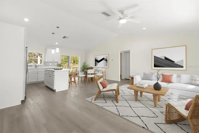 a living room with furniture and kitchen view
