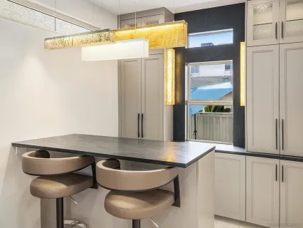 a large white kitchen with sink stove and refrigerator