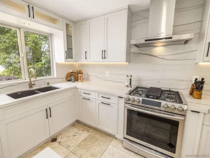 a bedroom with a large bed and a chair