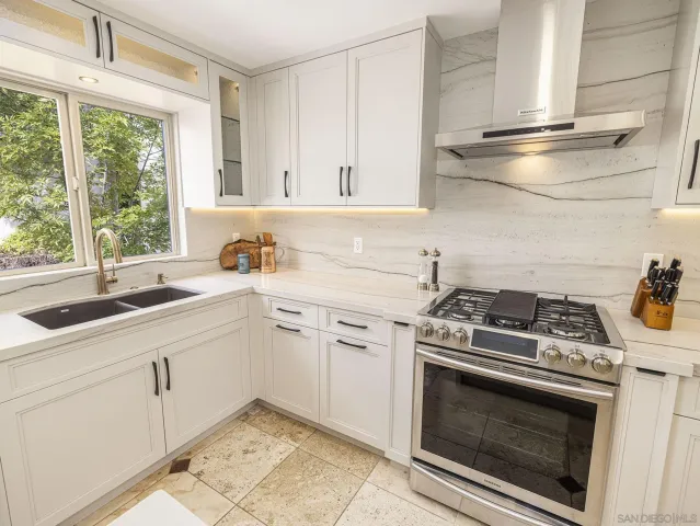 a bedroom with a large bed and a chair