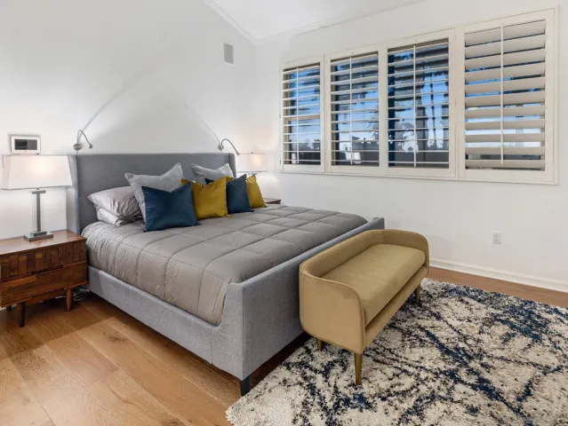 a bed sitting in a bedroom next to a window