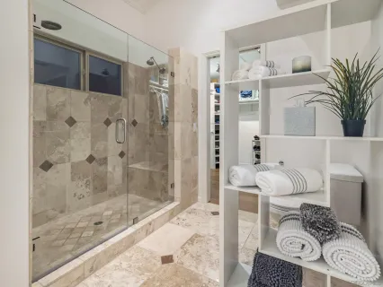 a spacious bathroom with a double vanity sink mirror and bathtub