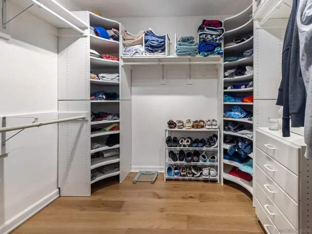 a bedroom with a bed and a night stand