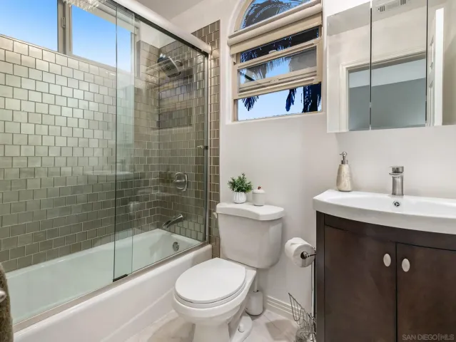 a large bed sitting in a bedroom next to a lamp