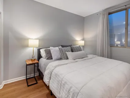 a bathroom with a granite countertop sink a toilet a mirror and shower