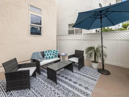 a view of a balcony with a table and chairs