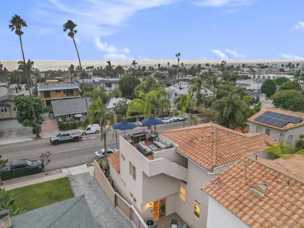 an aerial view of residential houses with city view