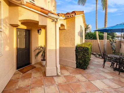 a view of balcony with wooden furniture and outdoor seating