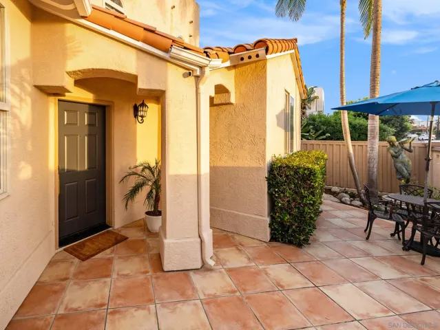 a view of balcony with wooden furniture and outdoor seating