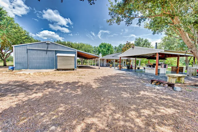 a view of a patio with a table chairs and a backyard