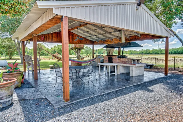 a view of a chairs and table in patio