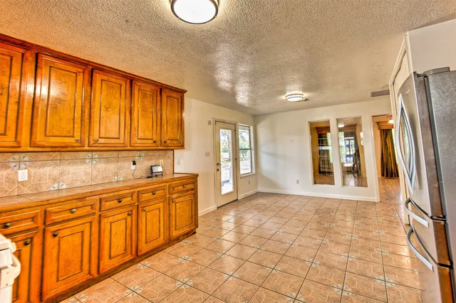 a view of a livingroom with a furniture a ceiling fan and window