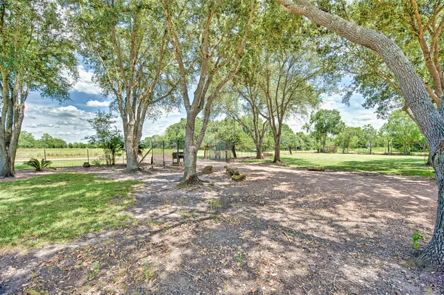 a view of an house with backyard and a garden