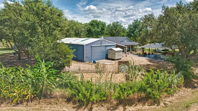 a view of a house with a yard and sitting area