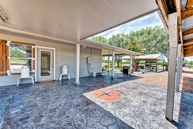 a view of a house with backyard porch and sitting area