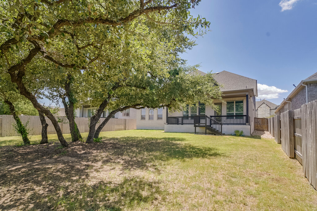 2920 Hadley Way Leander, TX 78641 - Photo 19 of 20 Mature trees offer shade and privacy to the sizable backyard with a charming rear deck.