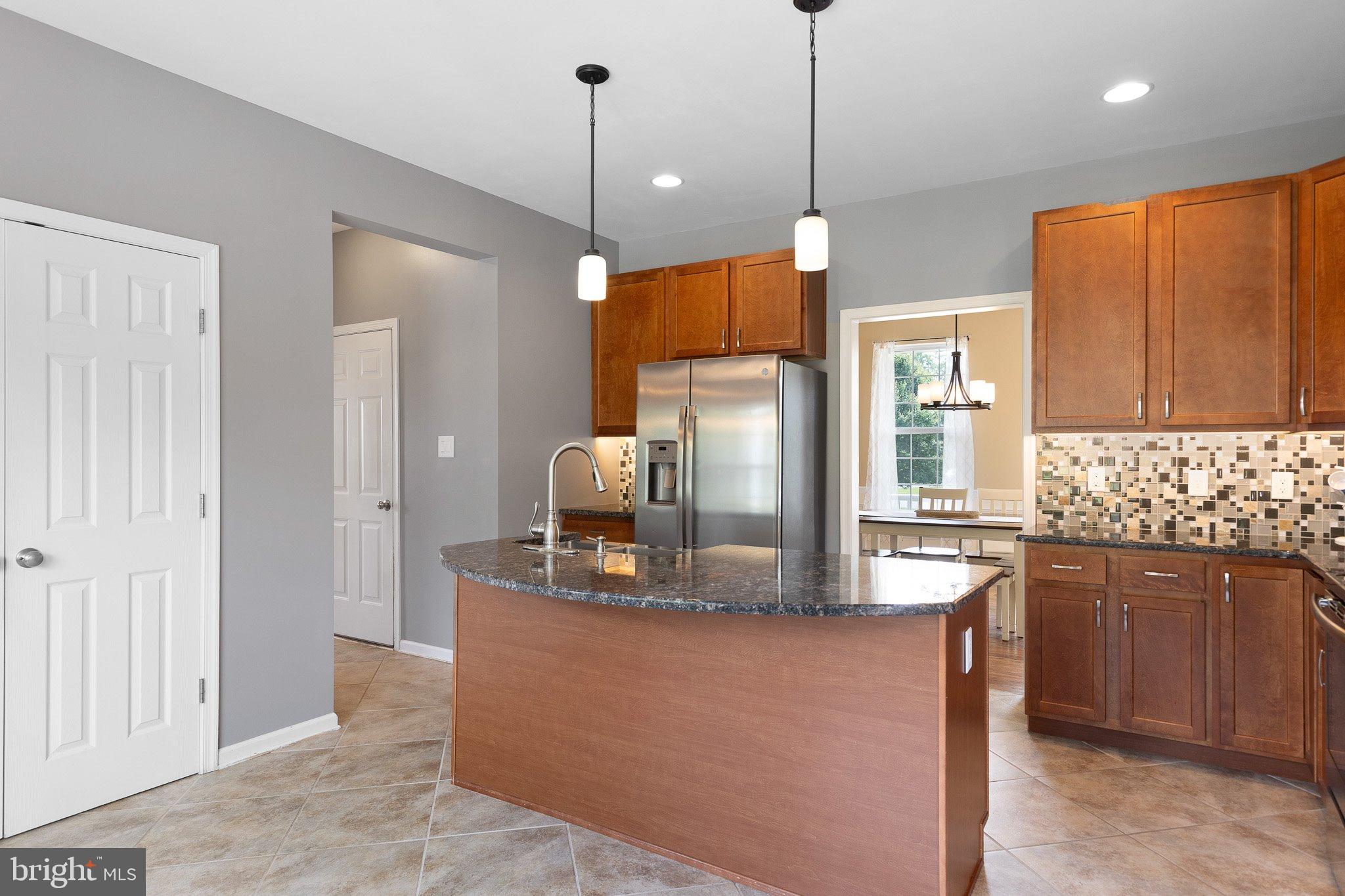 78 Lee Way Elkton, MD 21921 - Photo 12 of 39 a kitchen with stainless steel appliances granite countertop a sink a stove a refrigerator and island
