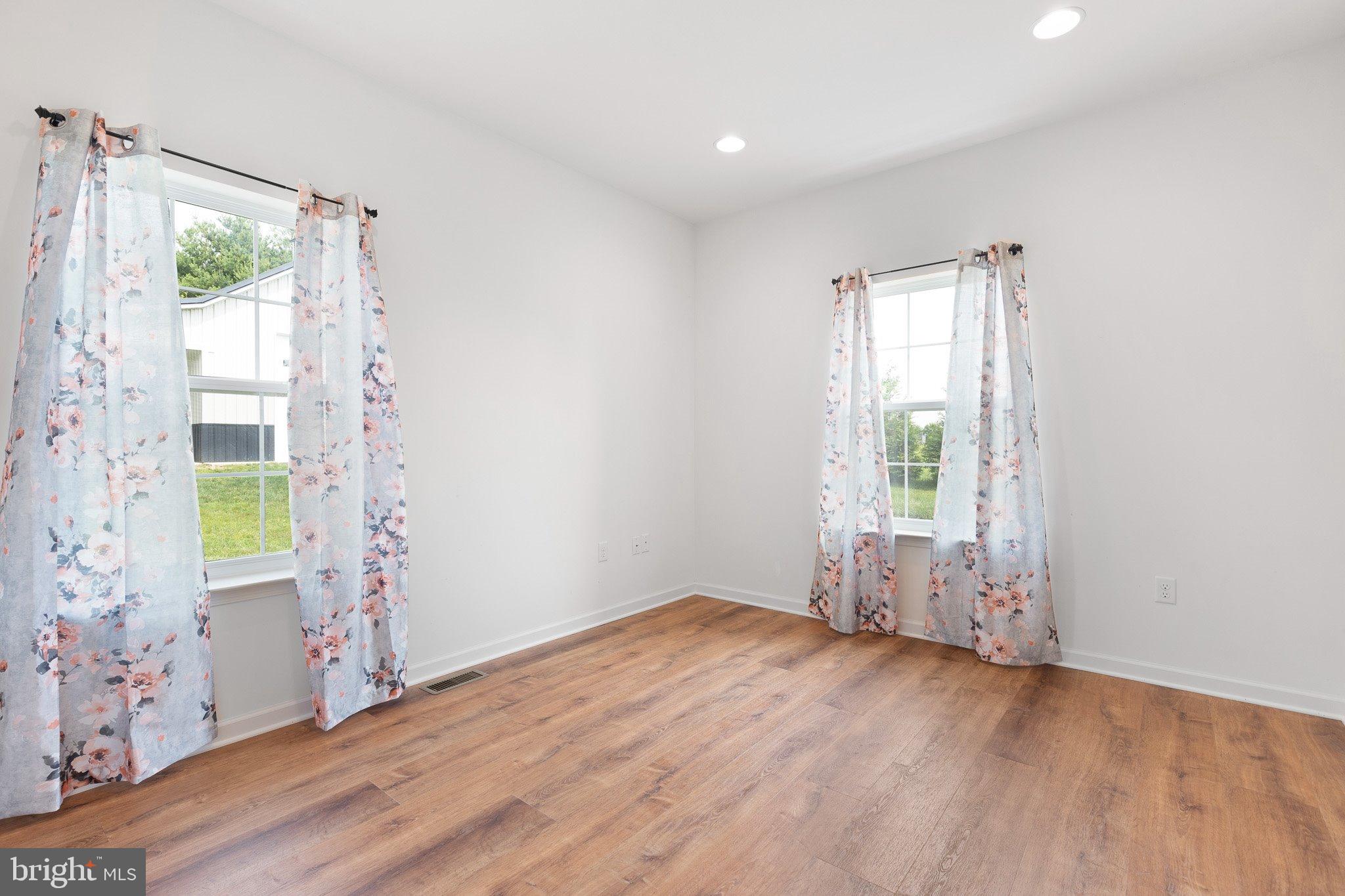 78 Lee Way Elkton, MD 21921 - Photo 18 of 39 an empty room with wooden floor and windows