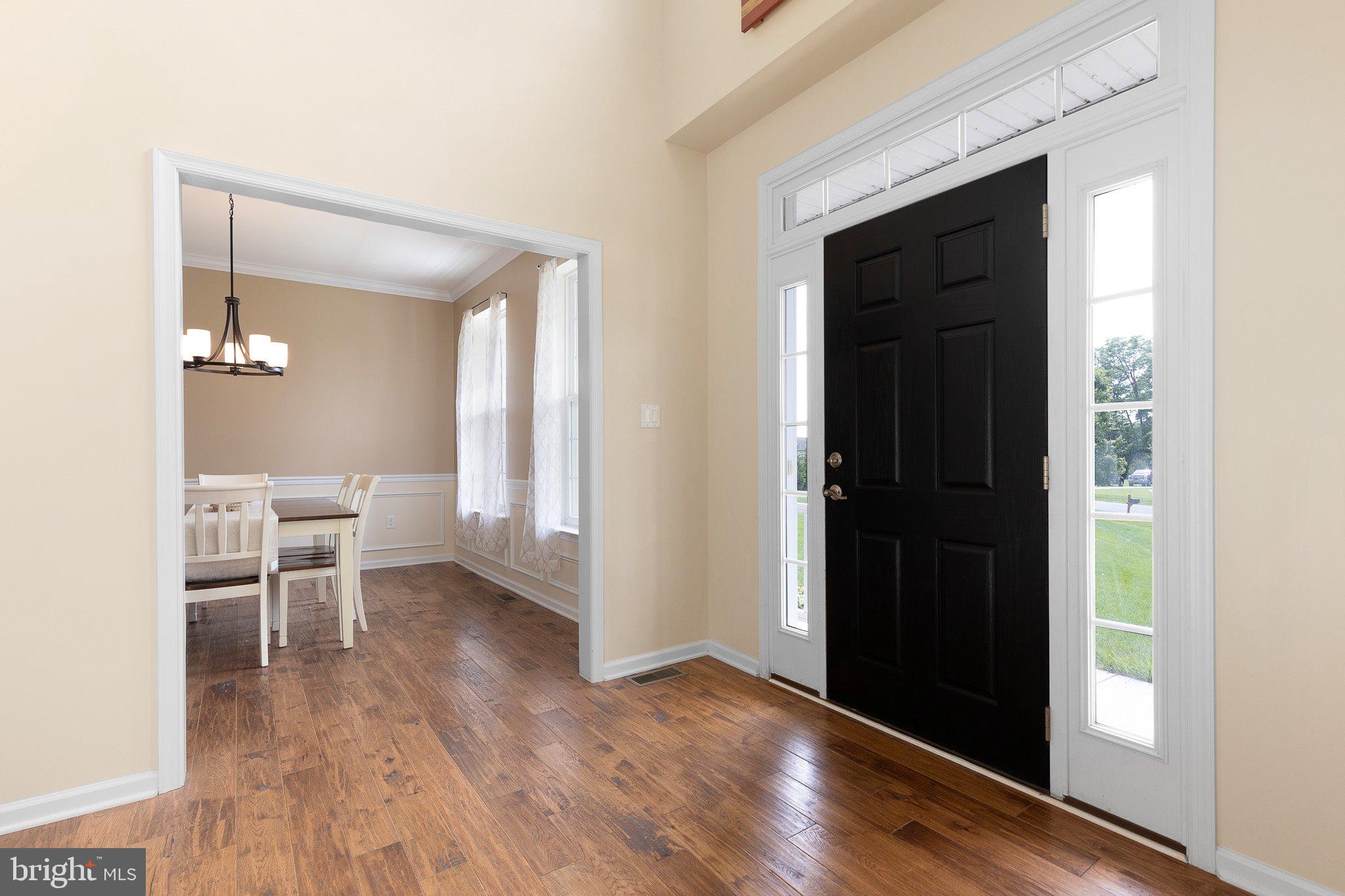 78 Lee Way Elkton, MD 21921 - Photo 5 of 39 wooden floor in a hall with an entryway and a dining table