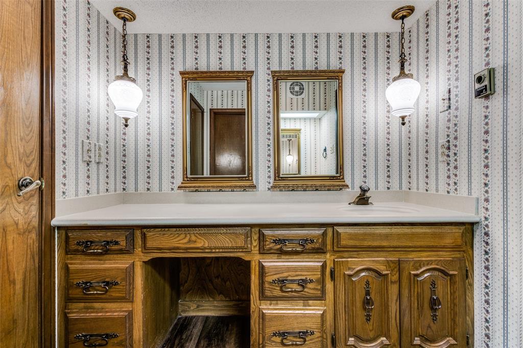 20967 Farm To Market 121 Gunter, TX 75058 - Photo 13 of 16 a bathroom with a sink mirror and a clock on the wall