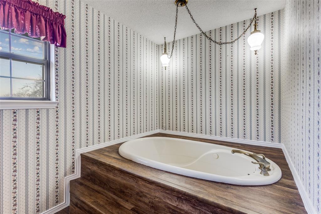 20967 Farm To Market 121 Gunter, TX 75058 - Photo 14 of 16 a bathroom with a tub and a shower