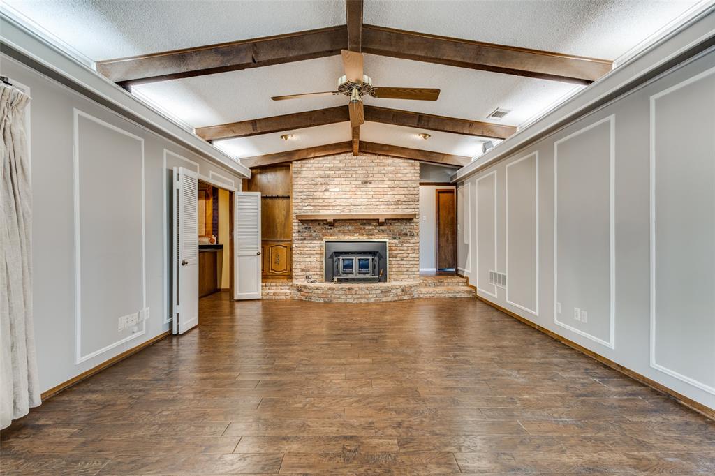 20967 Farm To Market 121 Gunter, TX 75058 - Photo 6 of 16 a view of an empty room with wooden floor fireplace and a window