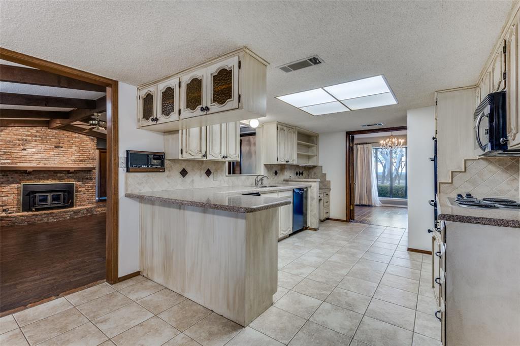 20967 Farm To Market 121 Gunter, TX 75058 - Photo 10 of 16 a kitchen with cabinets and window